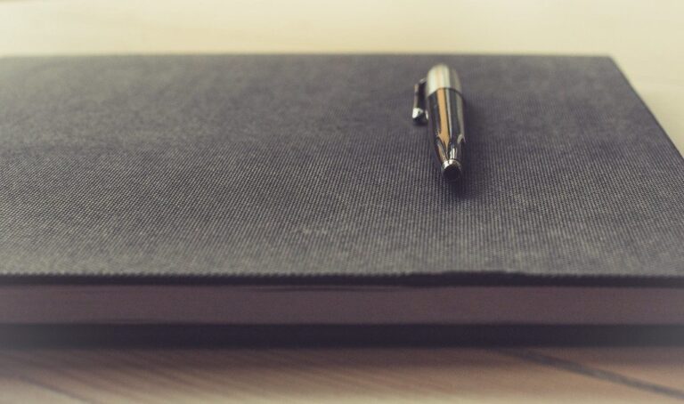 A paper notebook and pen used as a simple habit tracker