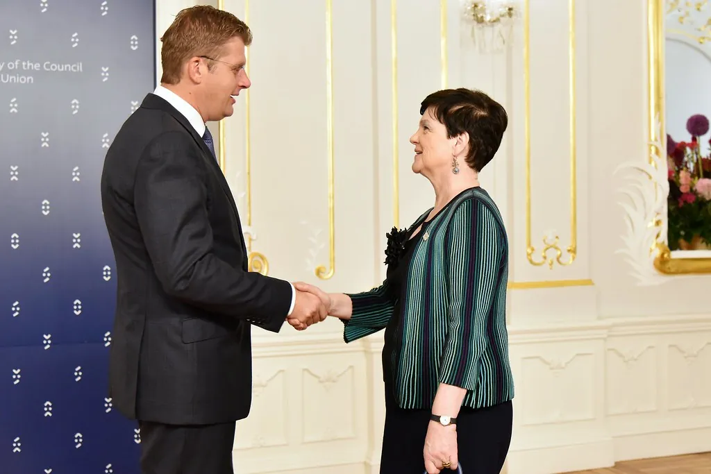 Two people shaking hands in an office