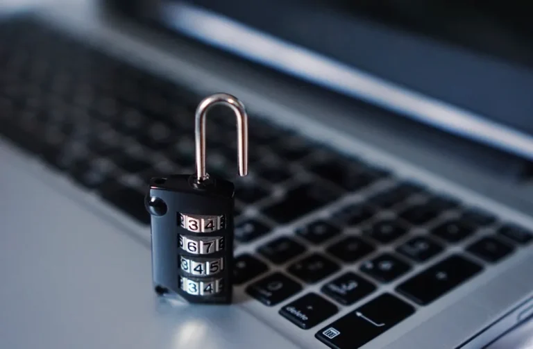 A combination padlock resting on a laptop keyboard