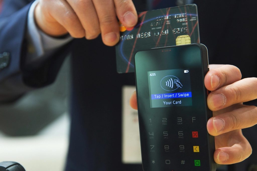 A credit card and phone for payment, comparing UPI and credit cards