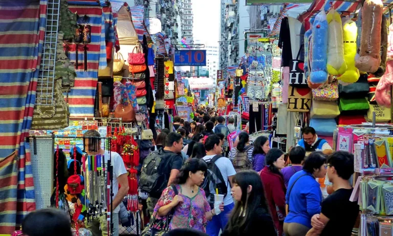 A busy street market with stalls and shoppers